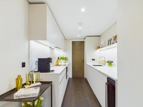 a kitchen with white counters and white cabinets at Be London - Chancery Lane Apartments in London