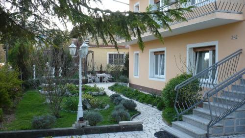 a garden in front of a house with a staircase at AUTOMOTODROM GROBNIK - Apartments and Rooms Skejić in Čavle