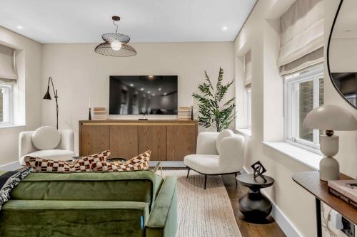 a living room with a couch and a tv at Be London - Chancery Lane Apartments in London