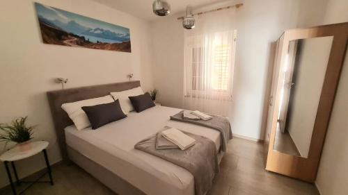 a bedroom with a large bed in a room at Apartman Joki in Novi Vinodolski