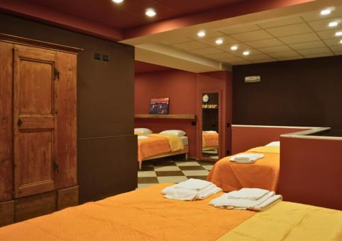 a room with two beds with towels on them at Immobiliare P&P - Arena House in Genova