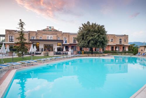 a large swimming pool in front of a building at Terra Umbra Hotel in Narni