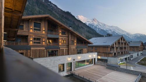 an aerial view of a building with mountains in the background at Résidence Le Cristal de Jade in Chamonix