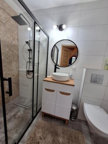 a bathroom with a sink and a mirror at Domek Górski Klimat in Białka Tatrzanska