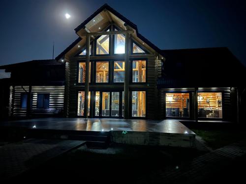a house at night with the moon in the sky at Mountain Lake JBS in Focşani
