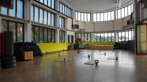 a gym with yoga mats on the floor in a building at Arena Albaro House in Genova