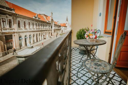 a balcony with a table and a view of a city at Vili Apartments in Oradea