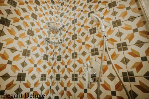 a shower in a bathroom with a tiled wall at Vili Apartments in Oradea