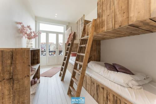 a room with two bunk beds and a staircase at Casa Diva – renovated house for 12 in Blankenberge in Blankenberge
