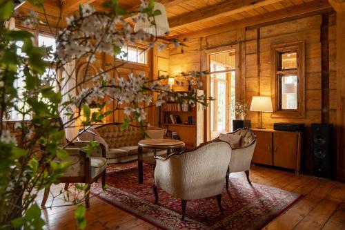 a living room with a couch and chairs at Butterfly Factory in Jonkowo