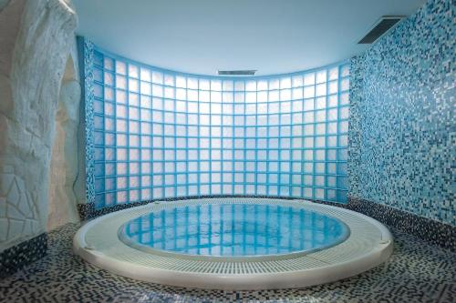 a hot tub in a bathroom with a window at Immobiliare P&P - Arena House in Genova