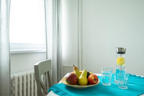 a plate of fruit on a table with a blue table cloth at Sun Valley Apartments in Maishofen