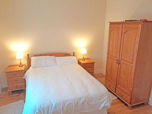a bedroom with a large bed with two night stands at Gweesalia m039 in Geesala