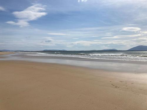 a sandy beach with waves in the ocean at Gweesalia m039 in Geesala