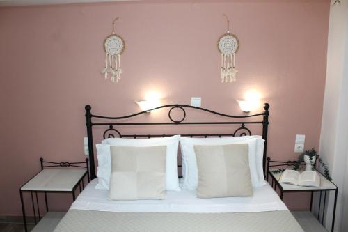 a bedroom with a large bed with white pillows at Fissas Rooms in Sivota