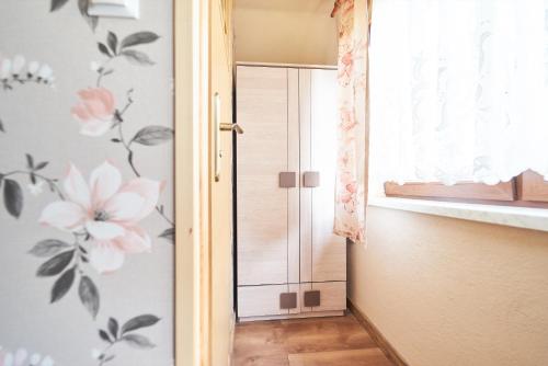 a room with a door with flowers on the wall at Apartamenty nad Młynówką in Chochołów
