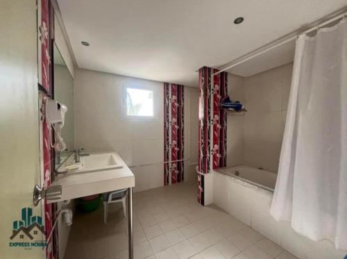 a bathroom with a sink and a tub and a shower at App S1 à l'hôtel Andalucia Beach in Bizerte