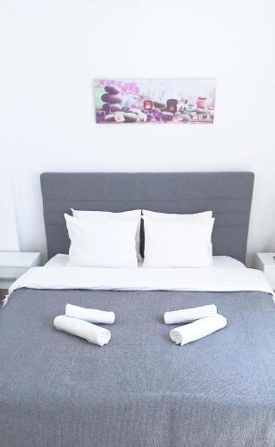 a bed with two white towels on top of it at Apartment in the center of Athens in Athens