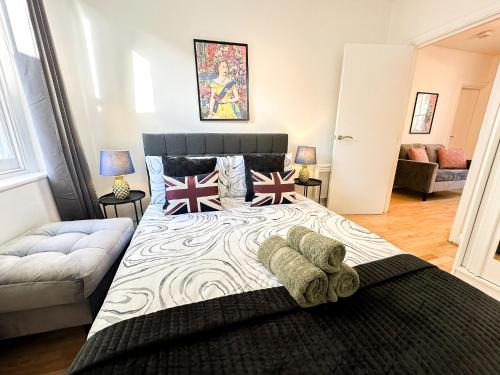 a bedroom with a large bed and a couch at Elegant 1BR Flat in the Heart of Hackney in London
