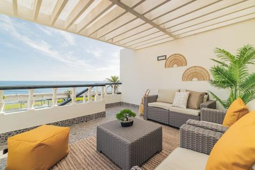 a living room with a view of the ocean at Casa do Helio - Beach House in Ponta Delgada
