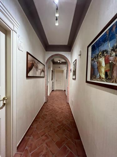 a hallway with paintings on the walls at Affittacamere D’annunzio in San Piero a Grado