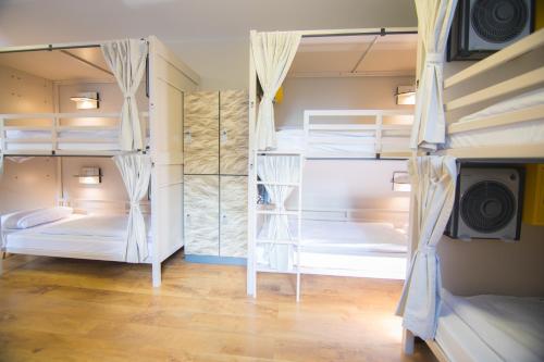 a room with three bunk beds in it at Wombat's City Hostel London in London
