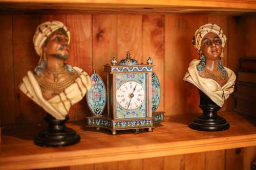 two statues and a clock on a shelf at Dar Dalila Fes in Fez