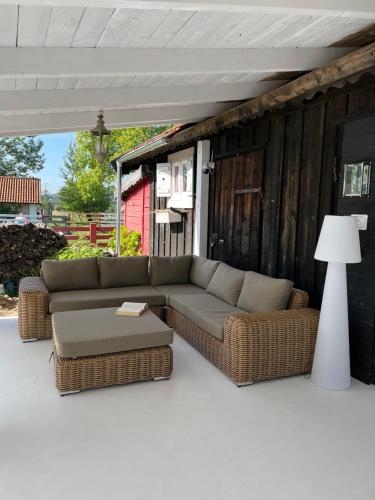 a couch and ottoman sitting on a patio at Siedlisko Blanki in Suryty