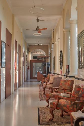 a hallway with a row of chairs in a building at Elphinstone Hotel in Mumbai