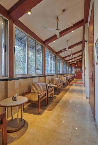 a row of tables and chairs in a waiting room at Elphinstone Hotel in Mumbai