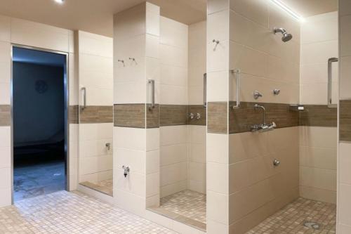 ein Bad mit einer ebenerdigen Dusche und Glastüren in der Unterkunft Appartementvermittlung Mehr als Meer Objekt 36 in Niendorf