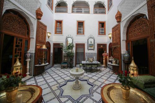 a large room with a fountain in the middle of a building at Dar Dalila Fes in Fès