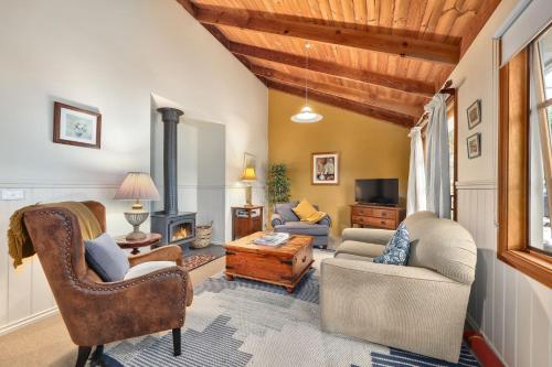 a living room with furniture and a fireplace at Jamieson Cottages - Cottage Three - Sleeps 4 in Howqua