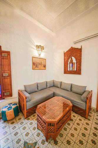 a living room with a couch and a table at Dar Dalila Fes in Fès