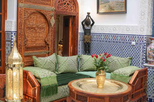 a living room with a couch and a table at Dar Dalila Fes in Fès