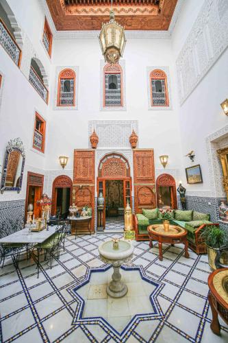 a living room filled with furniture and a chandelier at Dar Dalila Fes in Fès