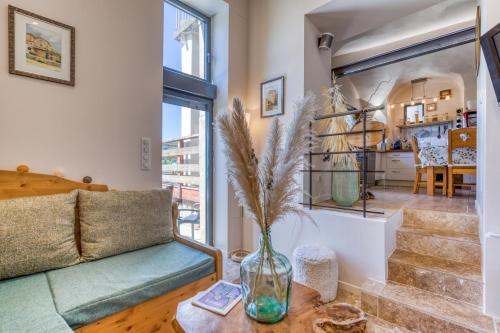 a living room with a couch and a table at Maison de village in La Tour-sur-Orb