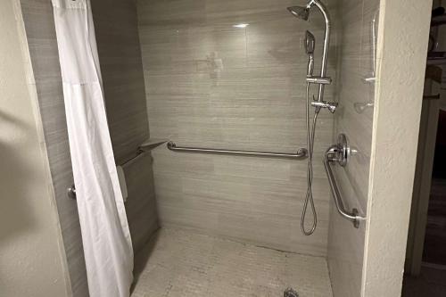 a bathroom with a shower with a shower curtain at Super 8 by Wyndham Athens TX in Athens