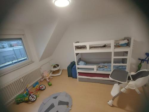 a toy room with a bunk bed and a room with toys at Komm ins Mildewarme Dachgeschoß in Pforzheim