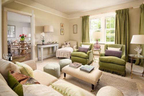 a living room with a couch and chairs and a table at Lane Cottage in Coldstream