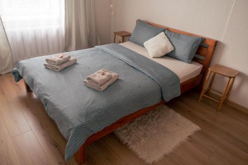 a bedroom with a bed with towels on it at Heart of Mitau in Jelgava