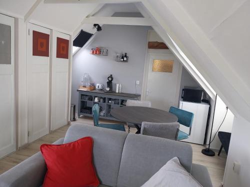 a living room with a couch and a table at De Posthoorn in Appelscha