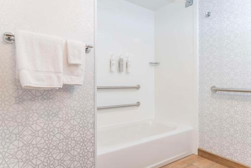 a bathroom with a tub and a shower with towels at Hampton Inn & Suites St. Louis-Chesterfield in Chesterfield