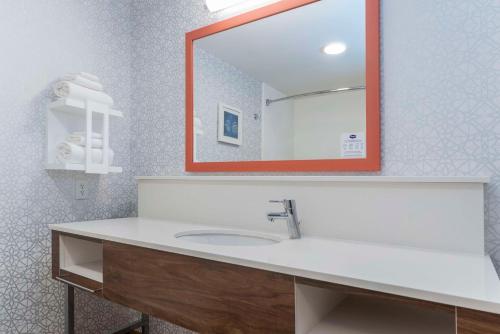 a bathroom with a sink and a mirror at Hampton Inn & Suites St. Louis-Chesterfield in Chesterfield