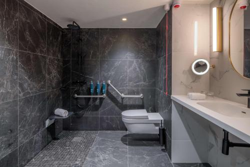 a bathroom with a toilet and a sink at Hilton Paris La Défense in Puteaux