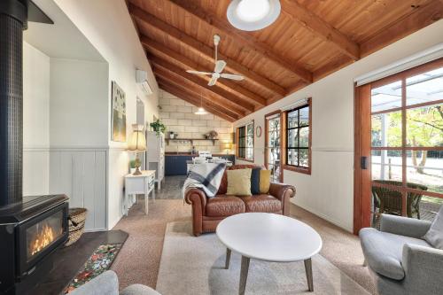 a living room with a couch and a fireplace at Jamieson Cottages - Cottage TWO - Sleeps 4 in Howqua