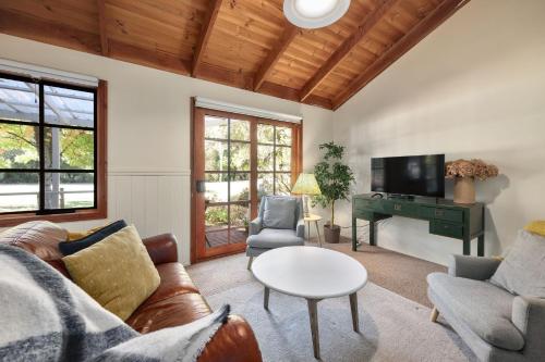 a living room with a couch and a table at Jamieson Cottages - Cottage TWO - Sleeps 4 in Howqua