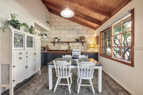 a kitchen with a table and four chairs at Jamieson Cottages - Cottage TWO - Sleeps 4 in Howqua