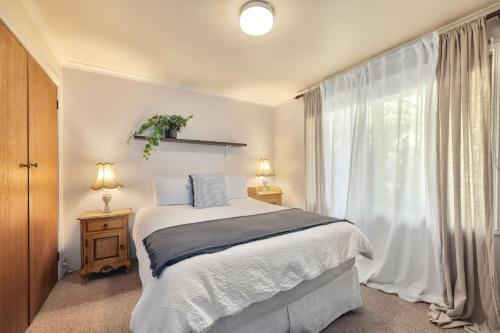 a bedroom with a bed and a large window at Jamieson Cottages - Cottage TWO - Sleeps 4 in Howqua
