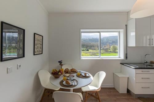 a kitchen with a table with a bowl of fruit on it at Casa da Ecovia in Arouca